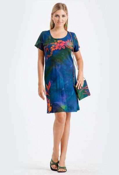 Woman modeling blue floral dress with matching bag