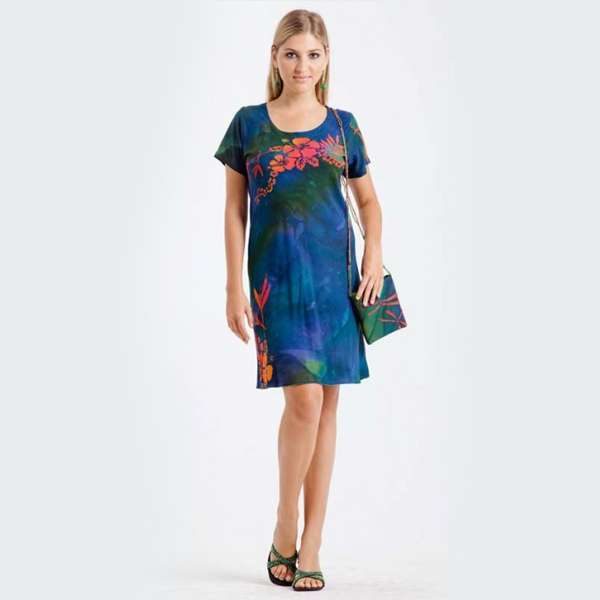 Woman modeling blue floral dress with matching bag