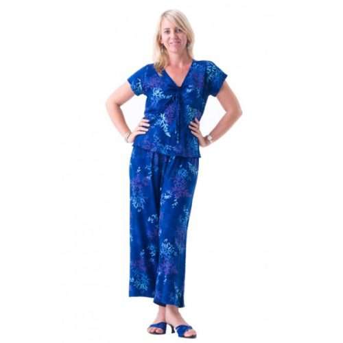 Woman in blue floral pajama set smiling