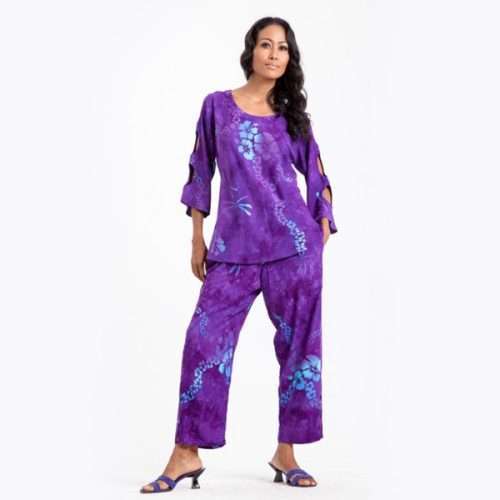 Woman modeling purple floral pantsuit with heels