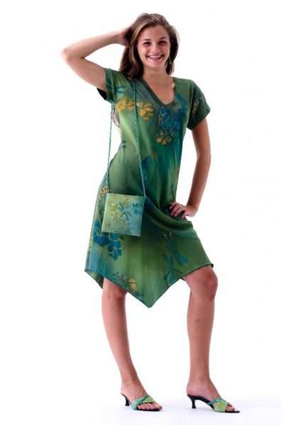 Woman in green floral dress with matching bag