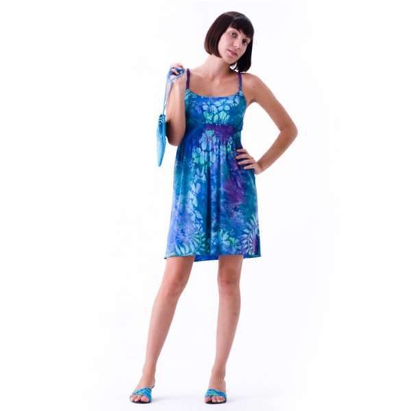 Woman in blue floral dress holding matching purse