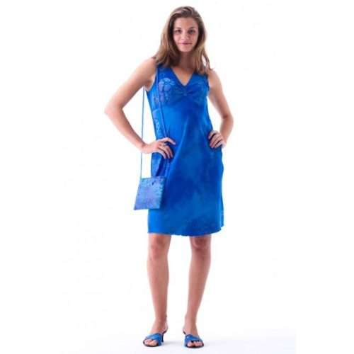Woman in blue dress holding matching purse