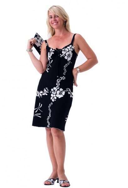 Woman in black floral sundress holding matching purse
