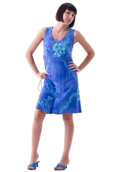 Woman in blue floral dress standing confidently