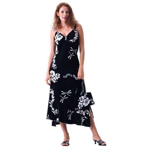 Woman in black floral dress holding matching purse