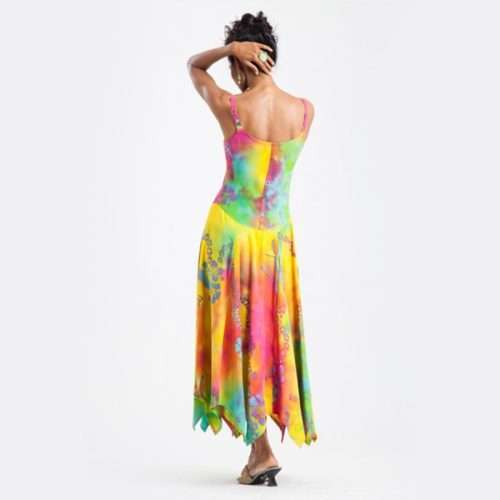 Woman in colorful tie-dye summer dress facing away