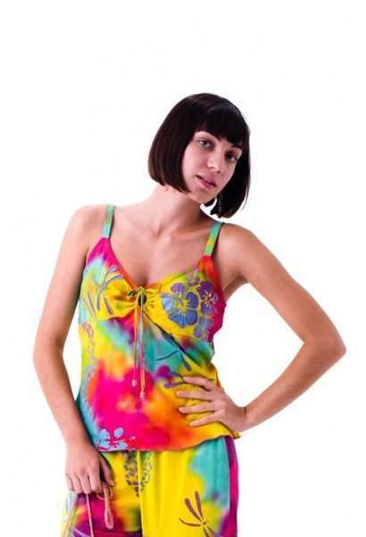 Woman in vibrant tie-dye summer outfit posing