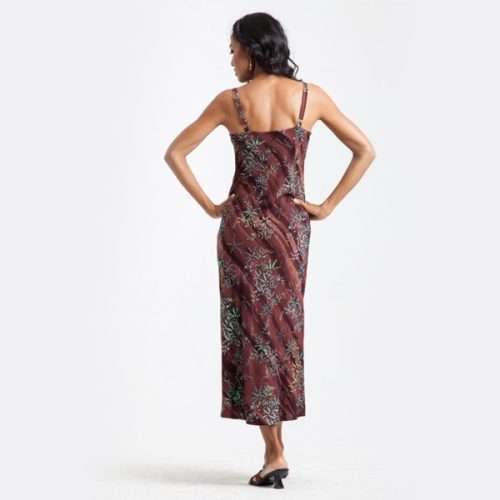 Woman in elegant floral dress facing away