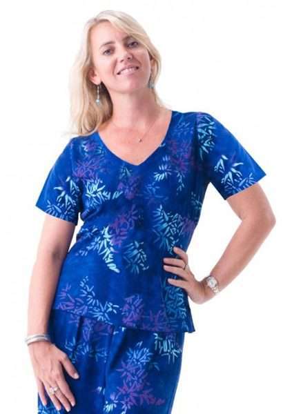 Woman in blue floral scrub suit smiling