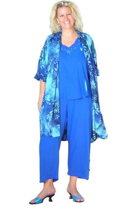 Woman smiling in blue dress and flowing shawl