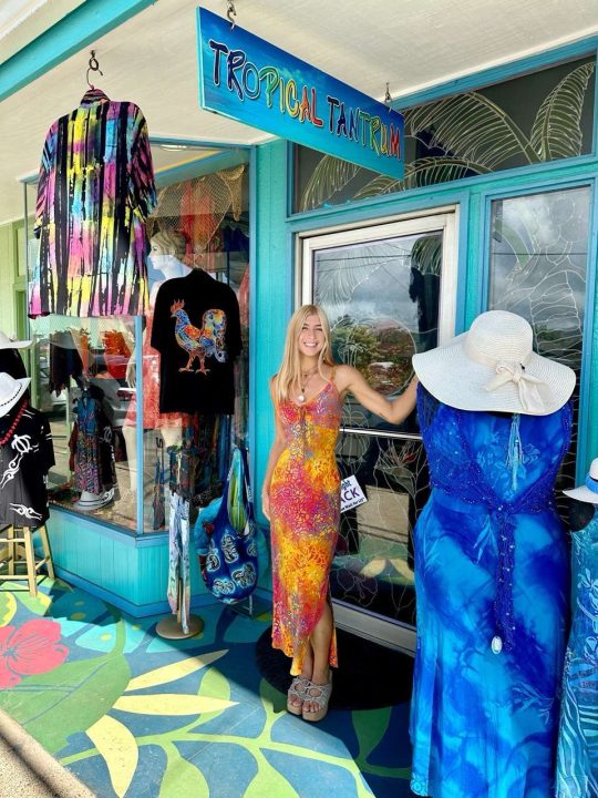 Woman smiling outside Tropical Tantrum store with dresses