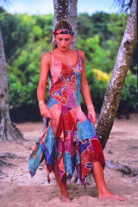 Woman in colorful patchwork dress on tropical beach